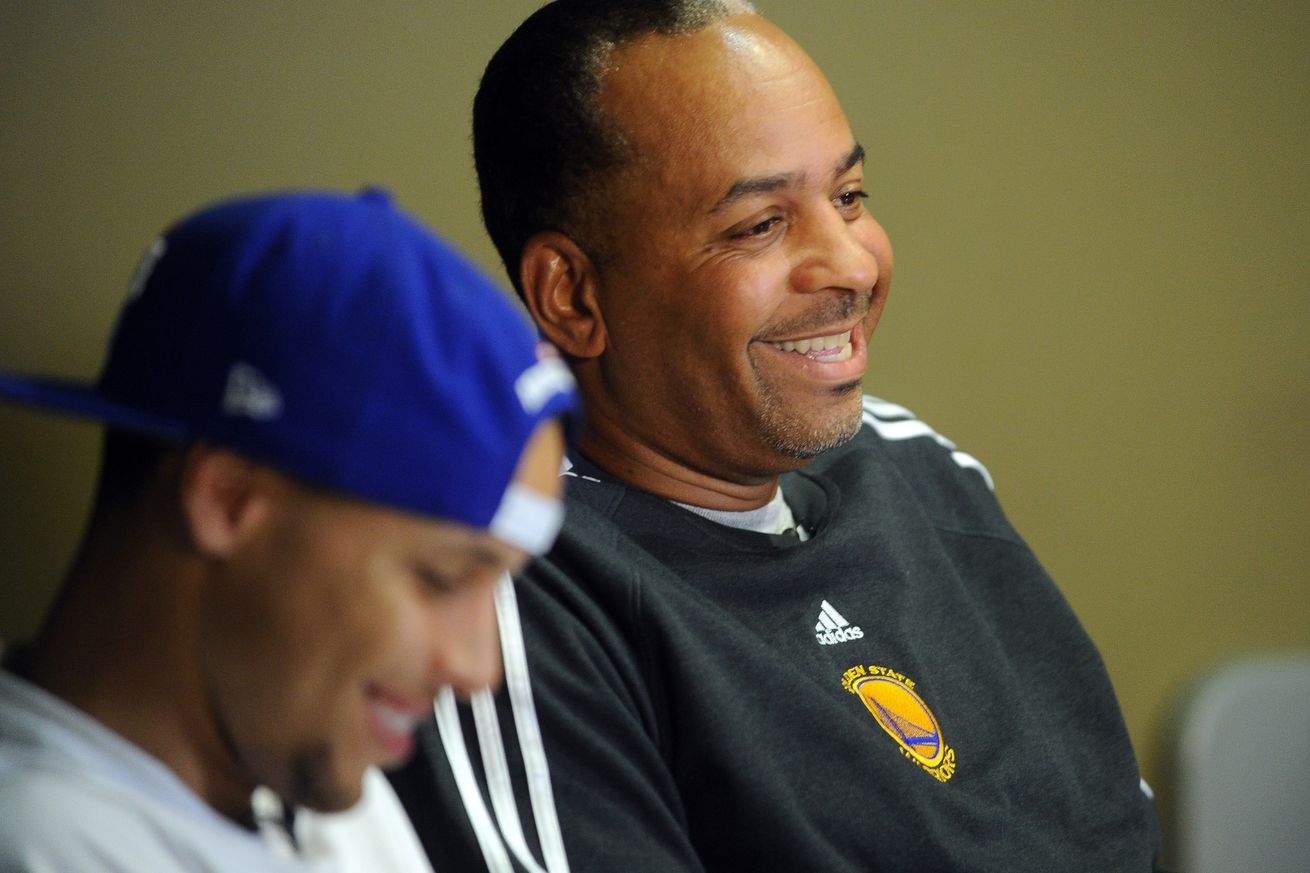 Golden State Warriors player Stephen Curry, left, listens to his father Dell Curry, a former National Basketball Association player, as he talks about having a son playing in the NBA during an interview in the Golden State Warriors training facility playe