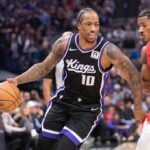 Nov 6, 2024; Sacramento, California, USA; Sacramento Kings forward DeMar DeRozan (10) drives to the basket against Toronto Raptors guard Ochai Agbaji (30) during the first quarter at Golden 1 Center.