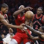 Toronto Raptors defenders led by Davion Mitchell attempt to stop Miami Heat big man Bam Adebayo